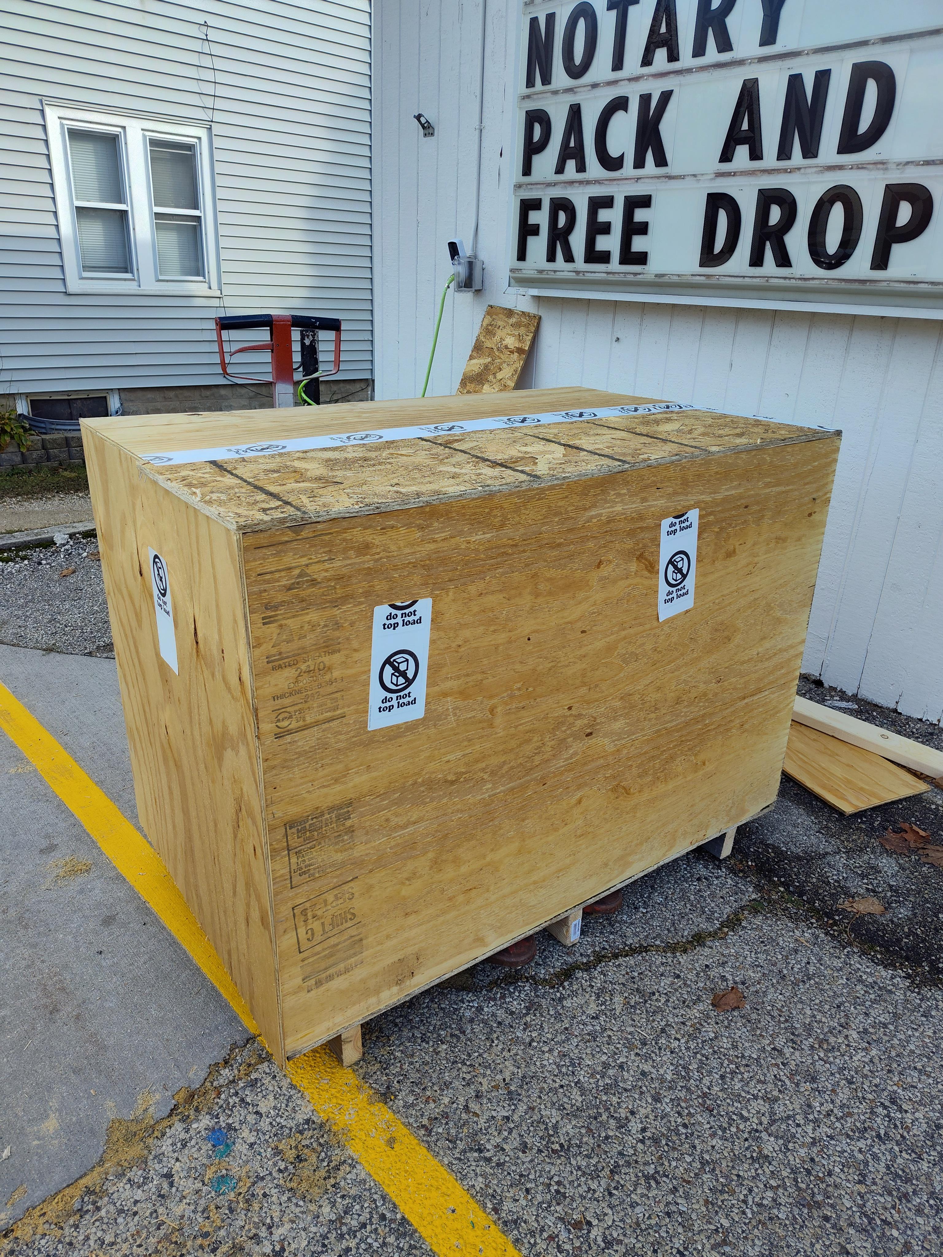 Large custom wooden shipping crate built outside Pack Ship and Mailboxes in Jackson Wisconsin